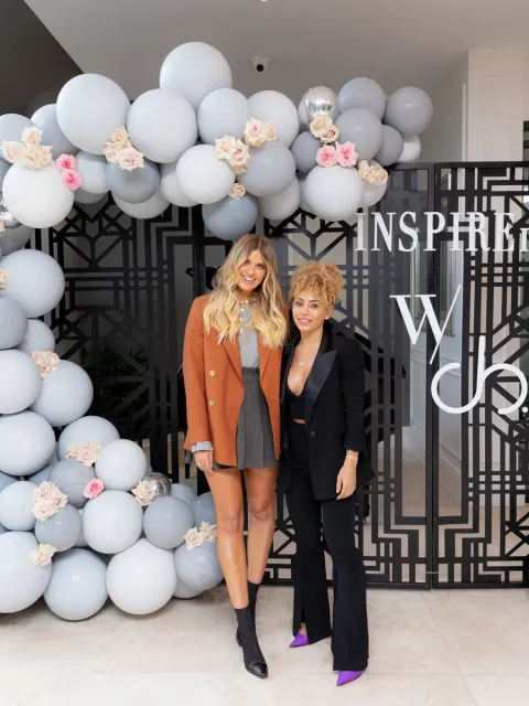 Guests photographed at the Wedded Wonderland Summit branded wall